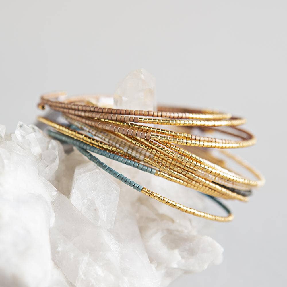 miyuki bead thin bracelet bangles stacked on raw quartz