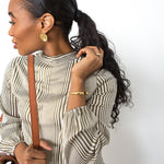 Open Brass Bracelet on Model in Black and White Striped Dress