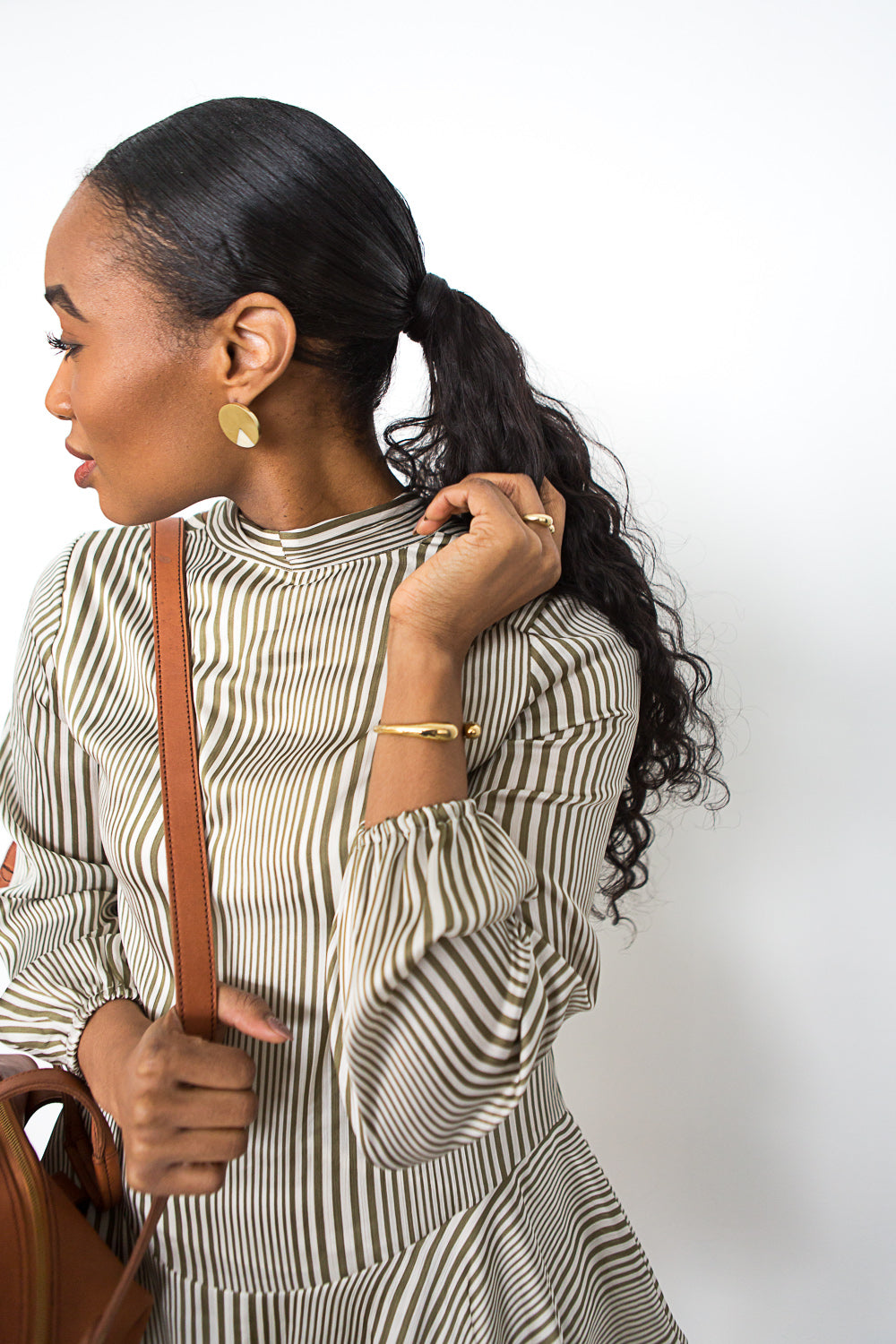 Open Brass Bracelet on Model in Black and White Striped Dress