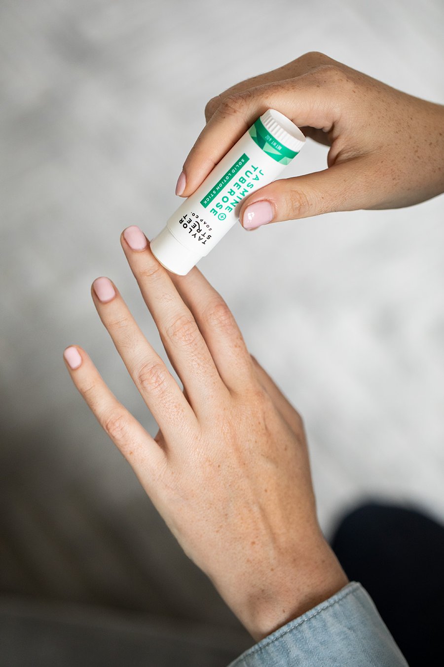 lotion stick on model's hand