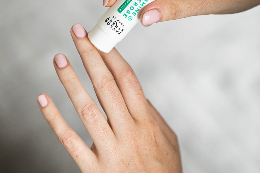 lotion stick on model's hand