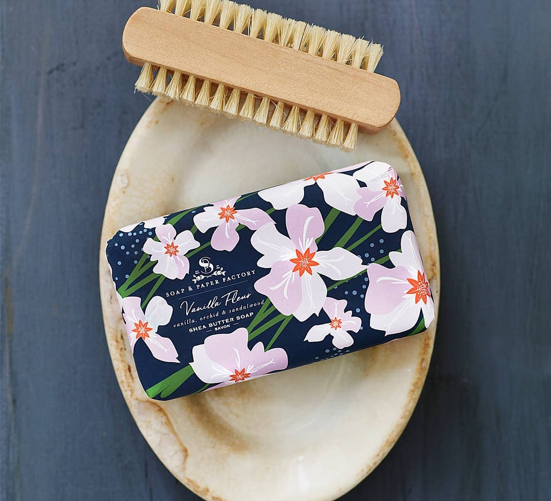vanilla fleur bar soap on dish with brush